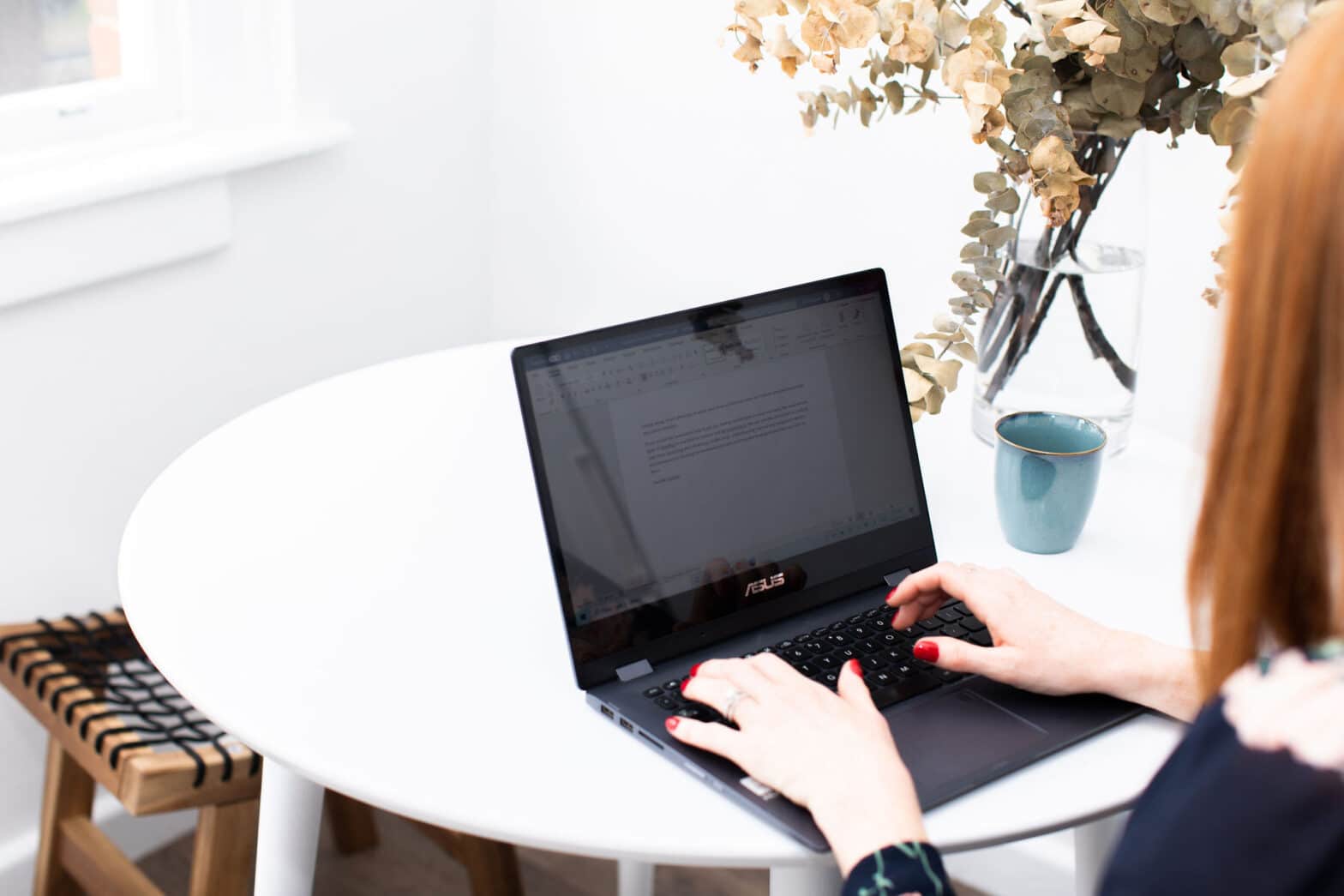 Jasmine Hanna, award submission writer, writing an award entry on a laptop
