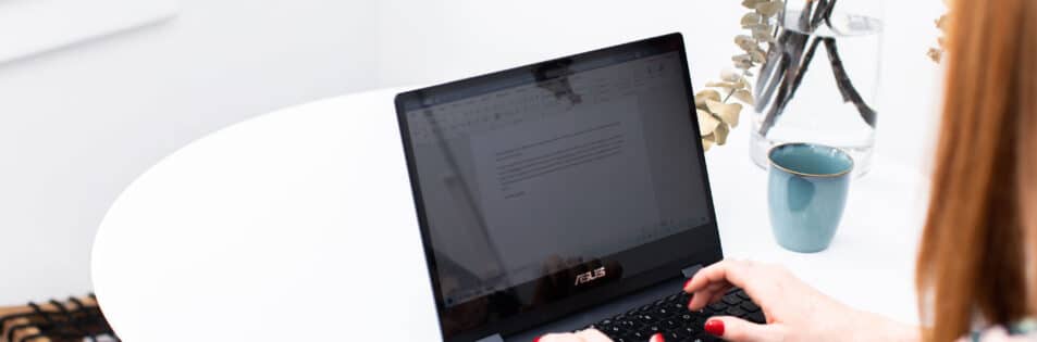 Jasmine Hanna, award submission writer, writing an award entry on a laptop